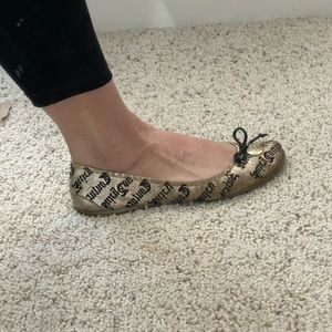 Black and gold Juicy Couture slip on flats with medium wear